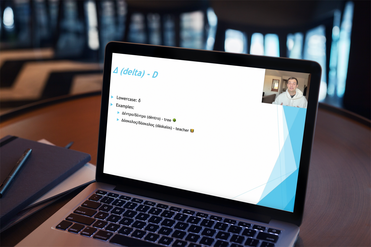 Laptop displaying a presentation with a blurred classroom background